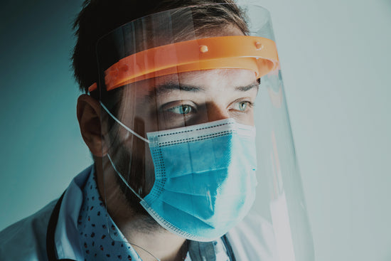 Doctor with a mask and visor to prevent catching or spreading SARS-COV-2