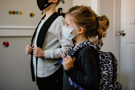 Two young students attending school